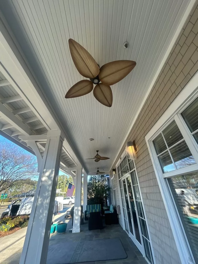 Covered porch ceiling with lighting and ceiling fans