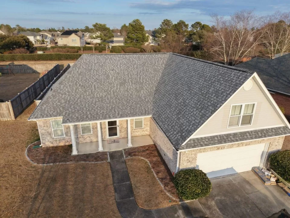 Gray shingle roof on a brick home viewed from above