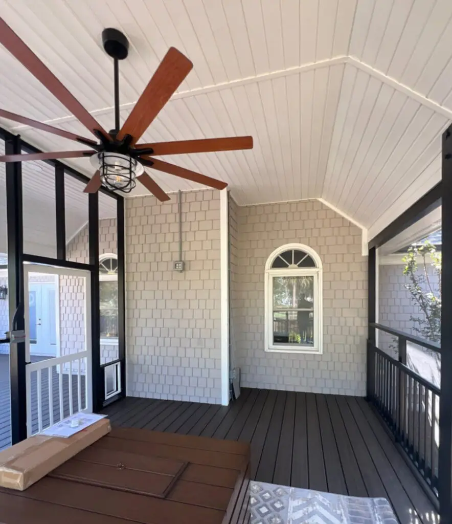 Inside a newly built outdoor living space in Wilmington NC featuring a custom deck and covered entertaining area by RGR Construction and Roofing, LLC.