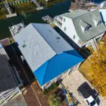 Standing seam metal roof and asphalt shingles using Landmark Pro by roofers in Oak Island