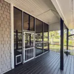 Inside a newly built outdoor living space in Wilmington NC featuring a custom deck and covered entertaining area by RGR Construction & Roofing.