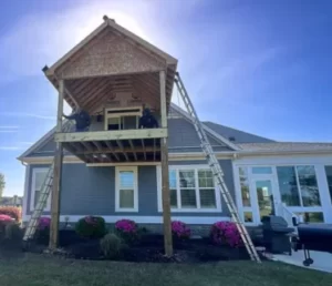 Covered porch addition under construction in Compass Pointe Leland NC by RGR Construction and Roofing with framing and roof structure in progress