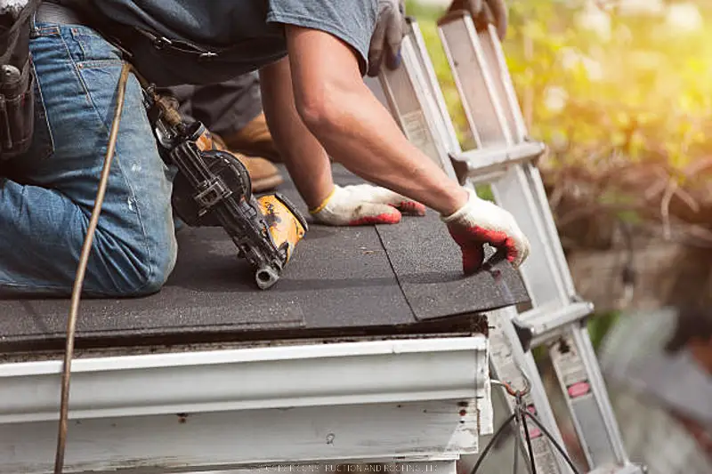 Professional roofer performing roof maintenance service on asphalt shingle roof in Wilmington NC by RGR Construction and Roofing, LLC
