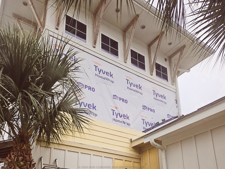Housewrap exposed beneath upper windows during an RGR exterior siding project