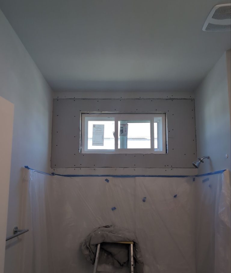 Bathroom window installed above an opened interior wall in Wilmington