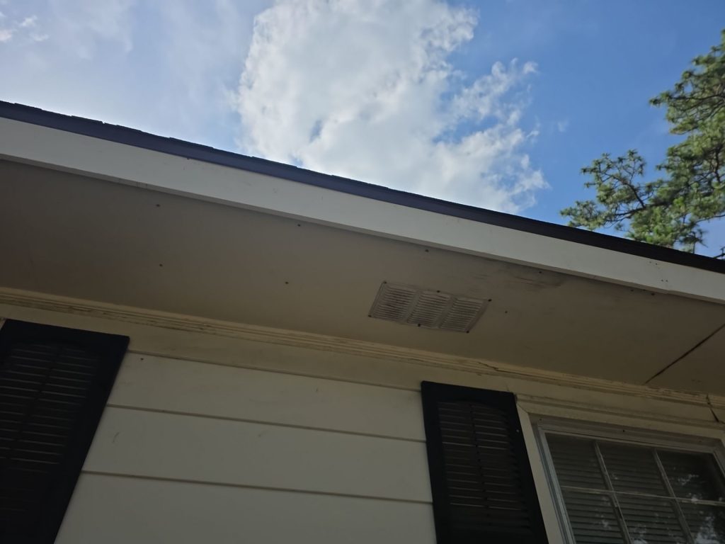 Repaired white fascia above a window at the Wilmington home