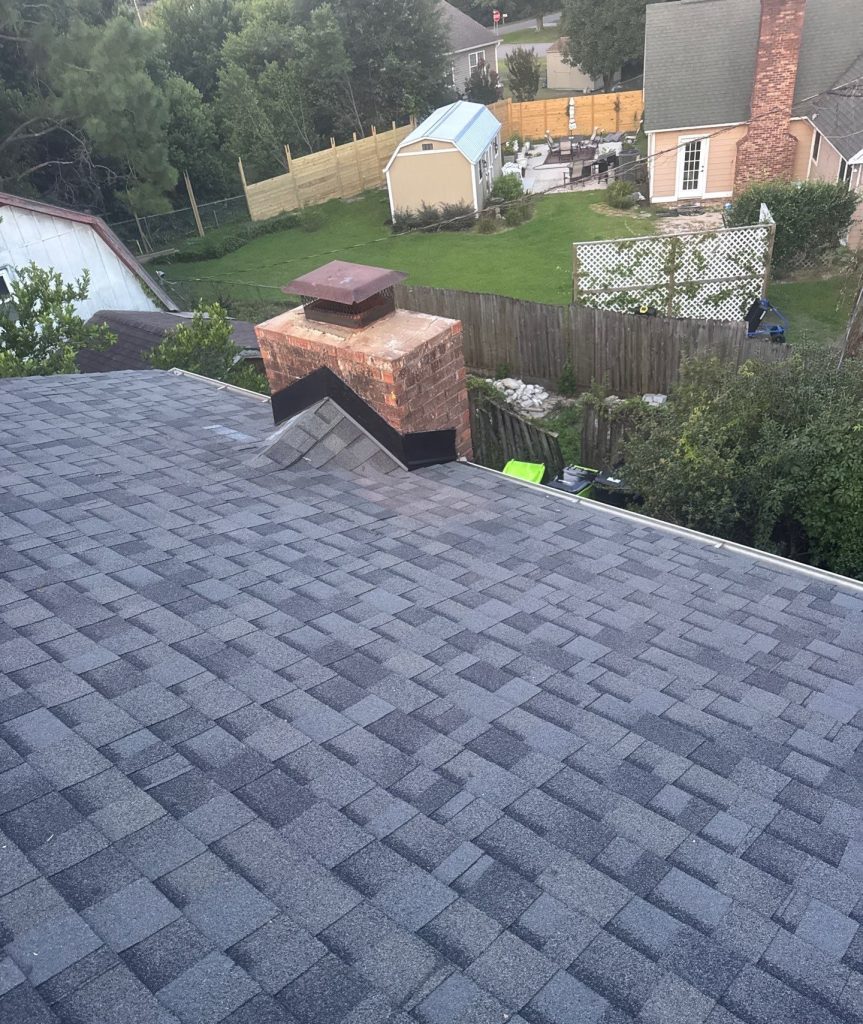 Brick chimney and adjoining shingle roof after the Wilmington repair