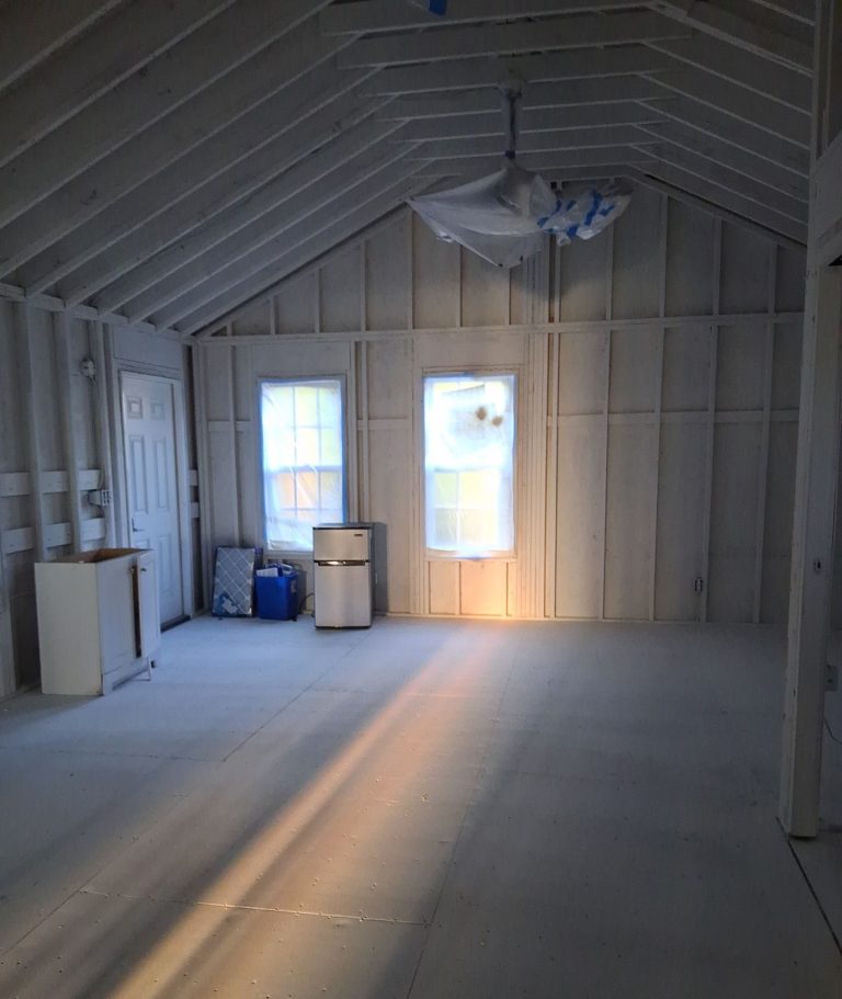 Interior wall studs and roof rafters surrounding a window during Wilmington restoration