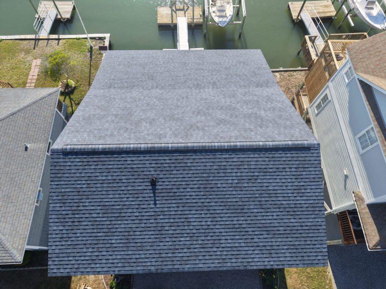 Overhead view of the new shingle roof planes and finished ridge caps on the same Holden Beach home