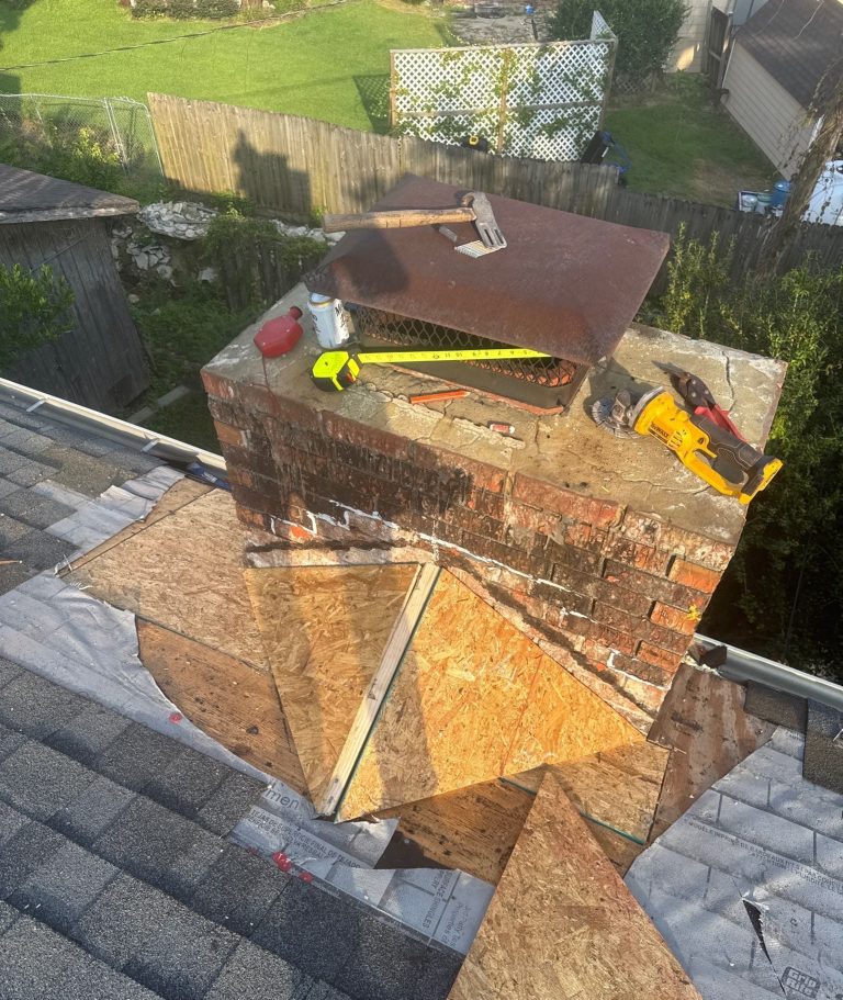 Wood and roofing materials at the chimney base during the repair