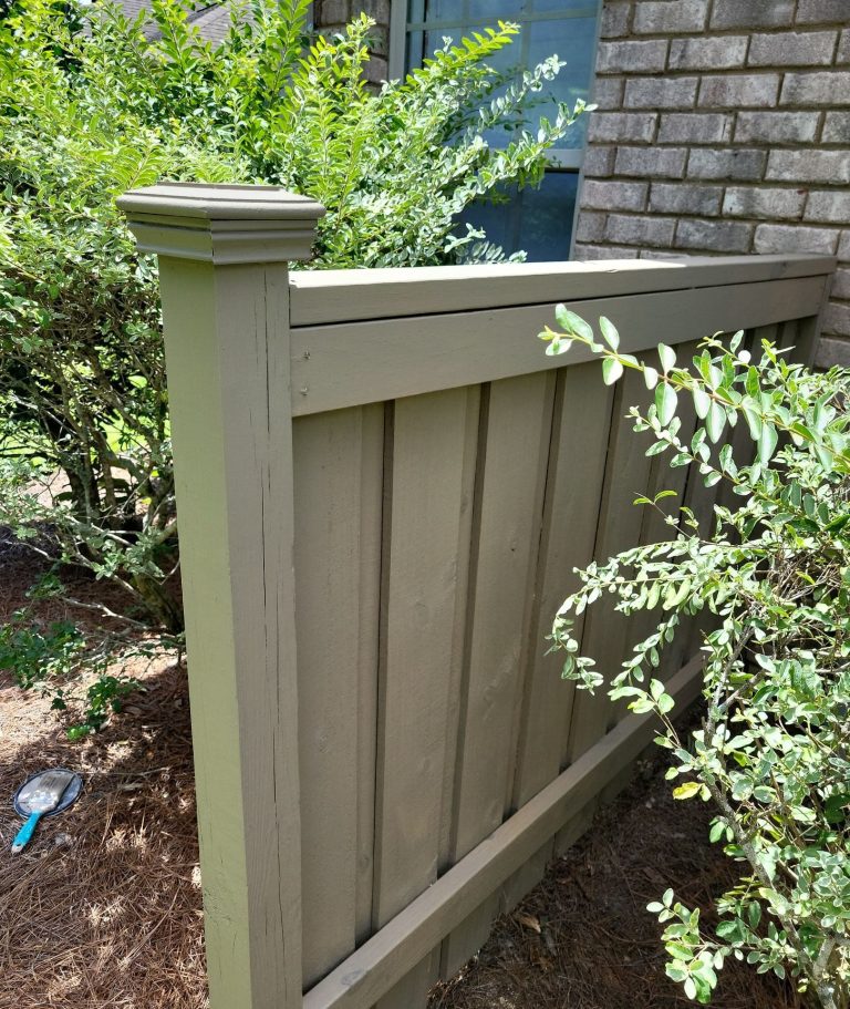 Close view of stained fence boards, horizontal rails and capped post