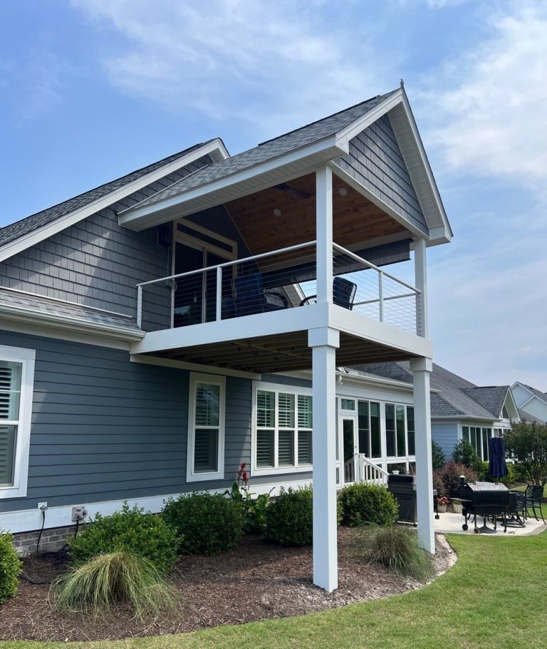 Right-side view of the completed Leland porch with cable railing and exterior trim