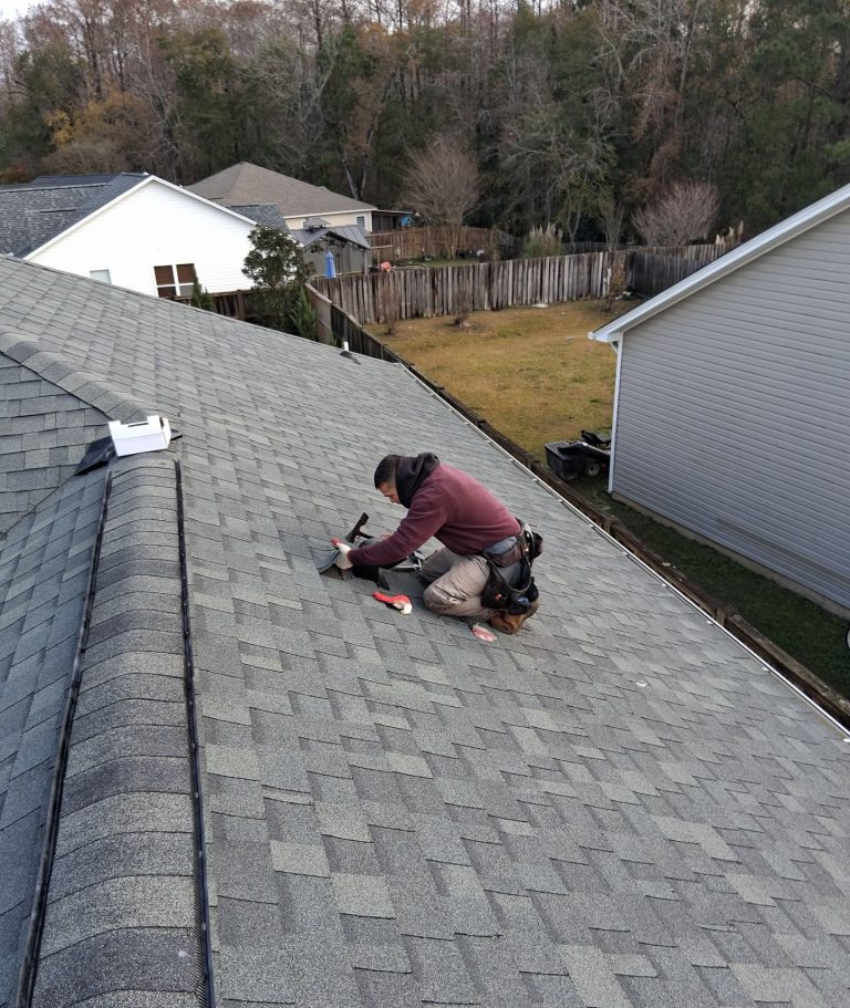 RGR roofer working on shingles around the roof louver in Leland