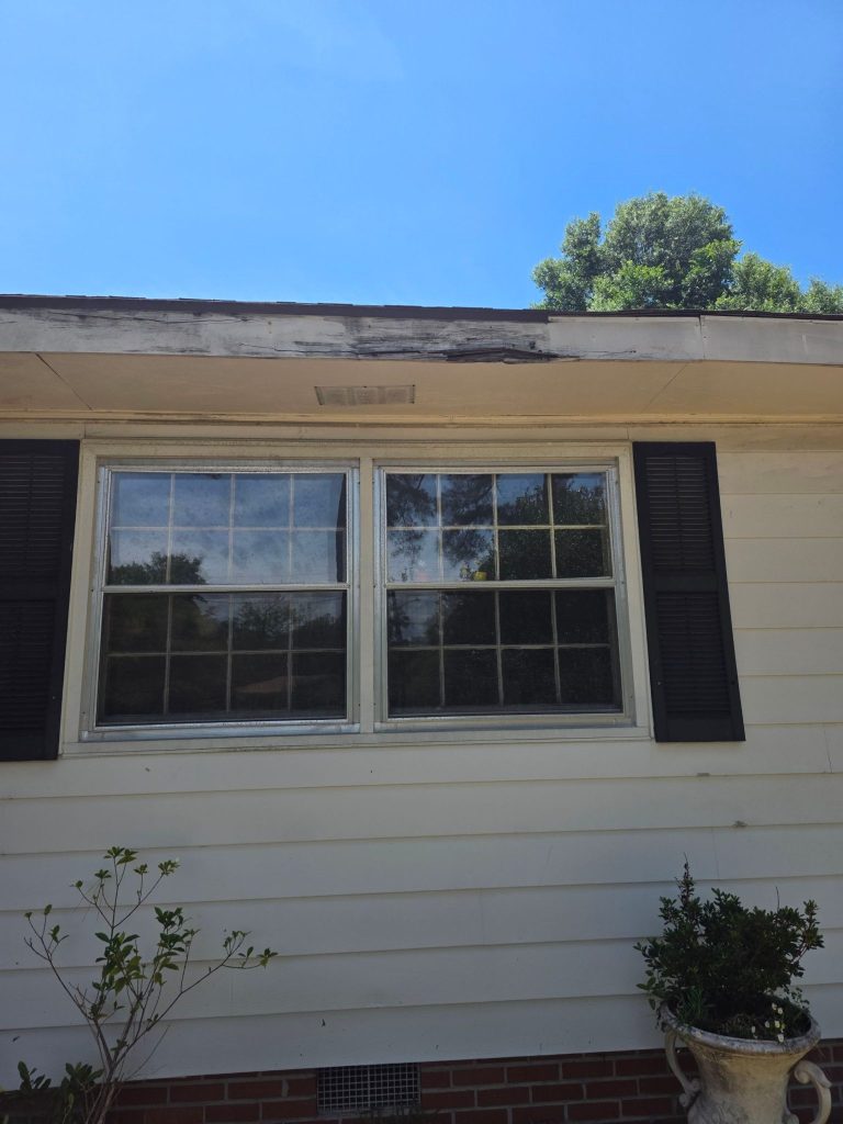 Deteriorated fascia above the window before repair in Wilmington