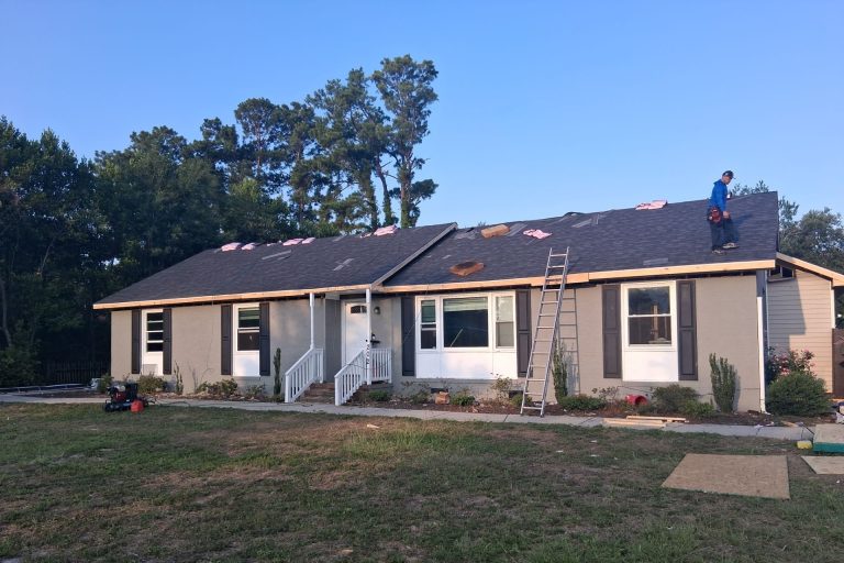Roofers installing asphalt shingles on the Wilmington home during fire restoration