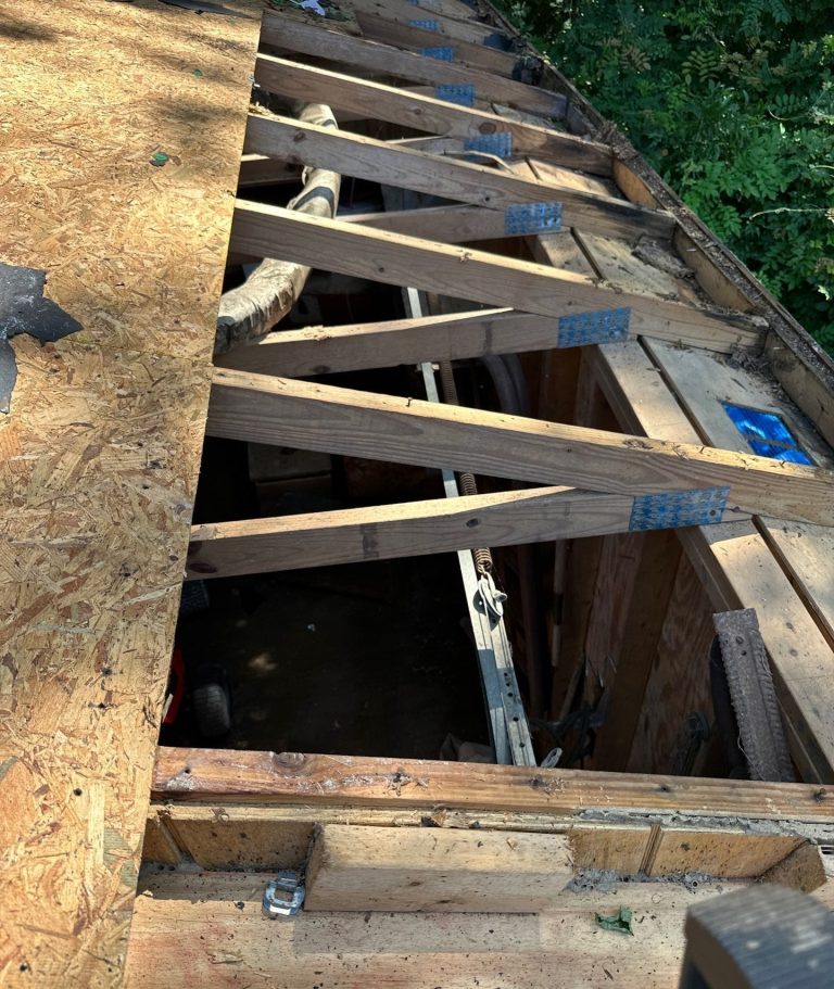 Open strip of roof decking exposing framing during the Wilmington roof replacement