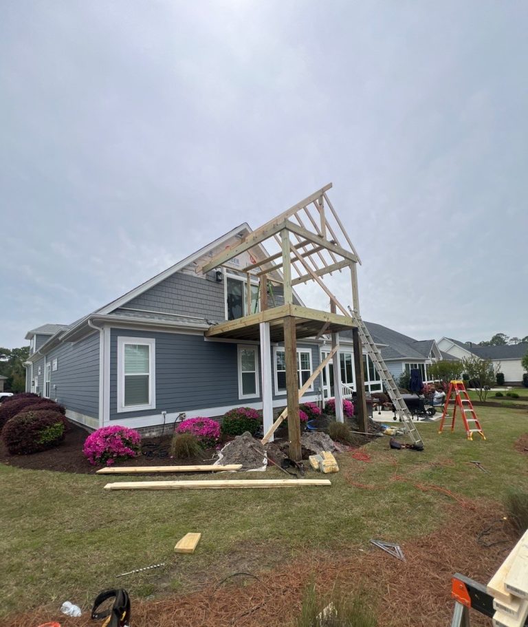 Exposed wood framing for the new elevated porch gable roof in Leland