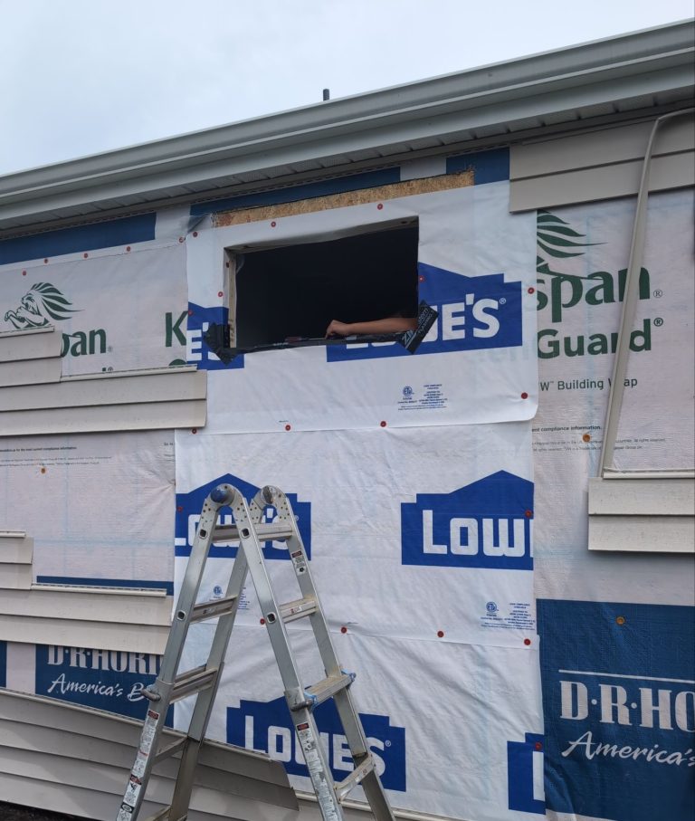Open bathroom window aperture through the exterior house wrap