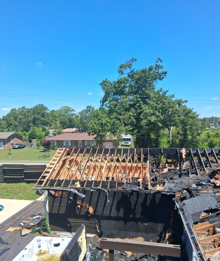 Charred roof framing and opened rooms before reconstruction at the Wilmington home