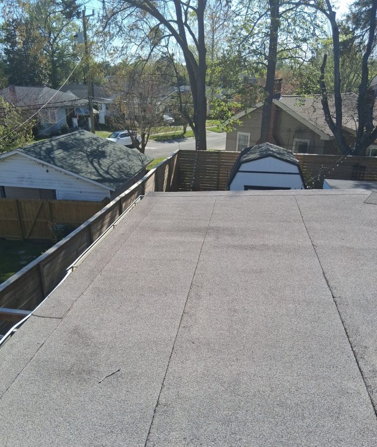 Finished low-slope roof field and edge viewed from above at the Wilmington home