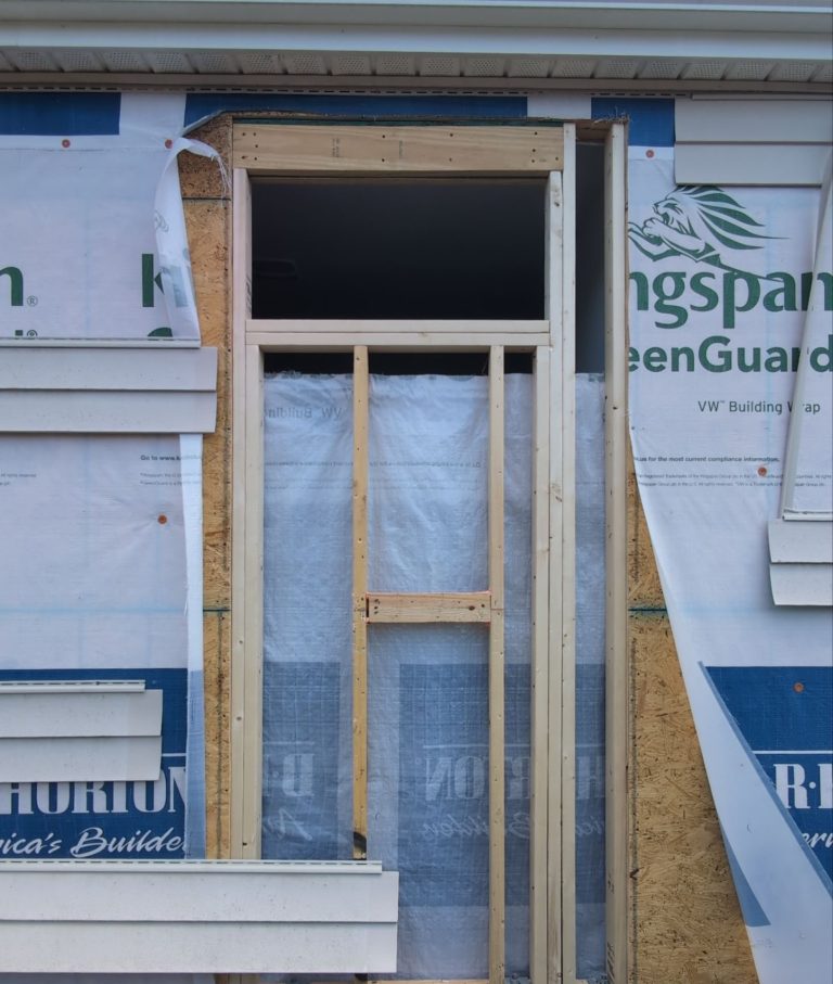 Framed exterior wall with a rectangular bathroom window opening
