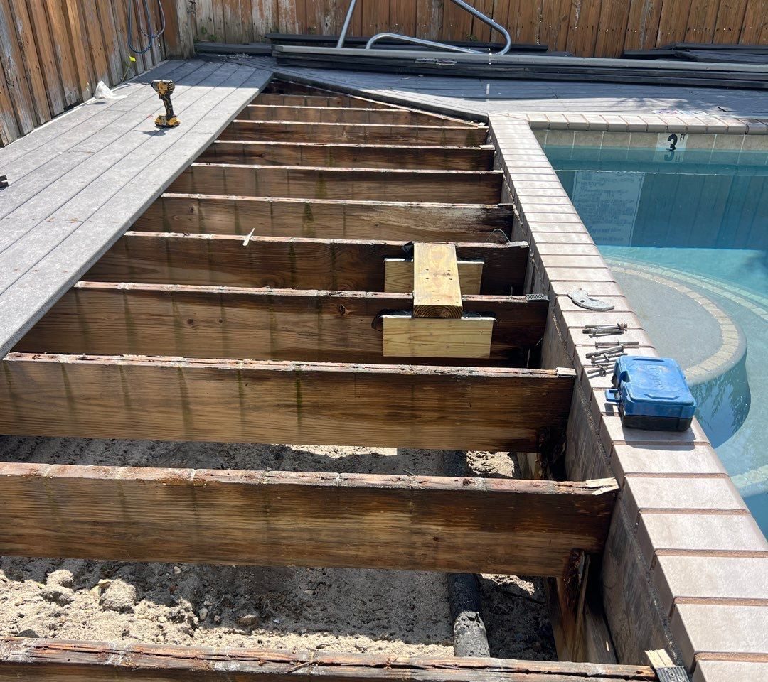 Exposed timber joists beside a swimming pool during RGR deck repair work in Carolina Beach.
