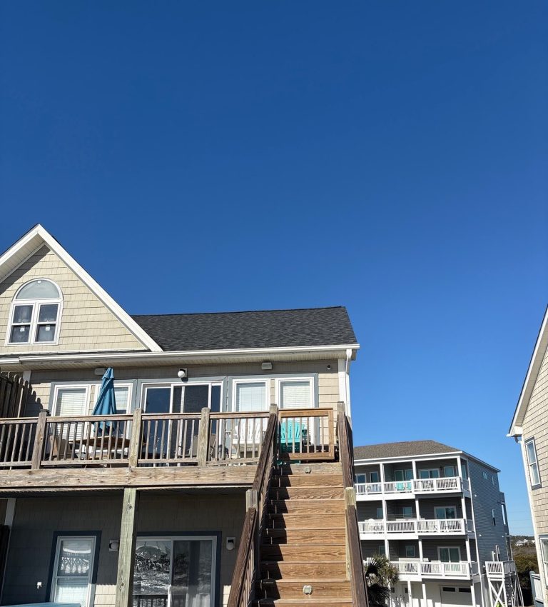 Completed dark shingle roof above the gable and upper deck in North Topsail Beach, NC